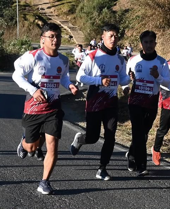 A runner on a hill road during the Assam Rifles Half Marathon in Shillong